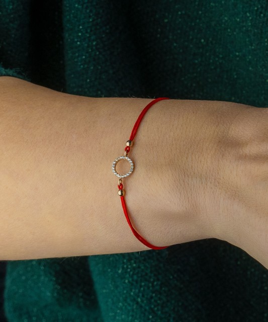 Red string bracelet with gold pendant