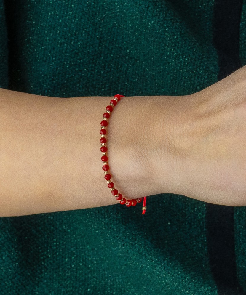 Red string bracelet with gold and onyxes