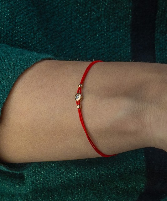Red string bracelet with zirconium pendant