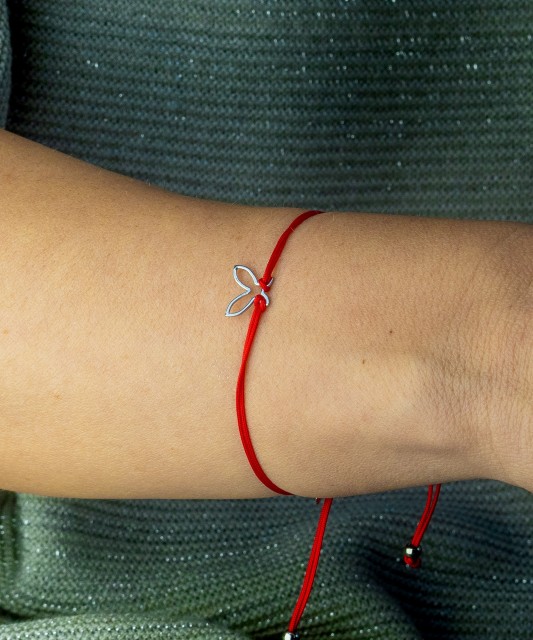 Red string bracelet with a silver pendant