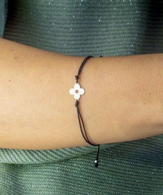 Black string bracelet with a silver pendant