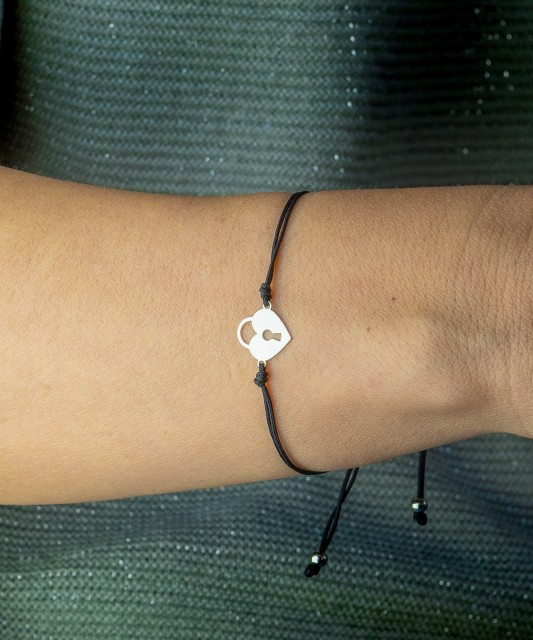 Black string bracelet with a silver pendant