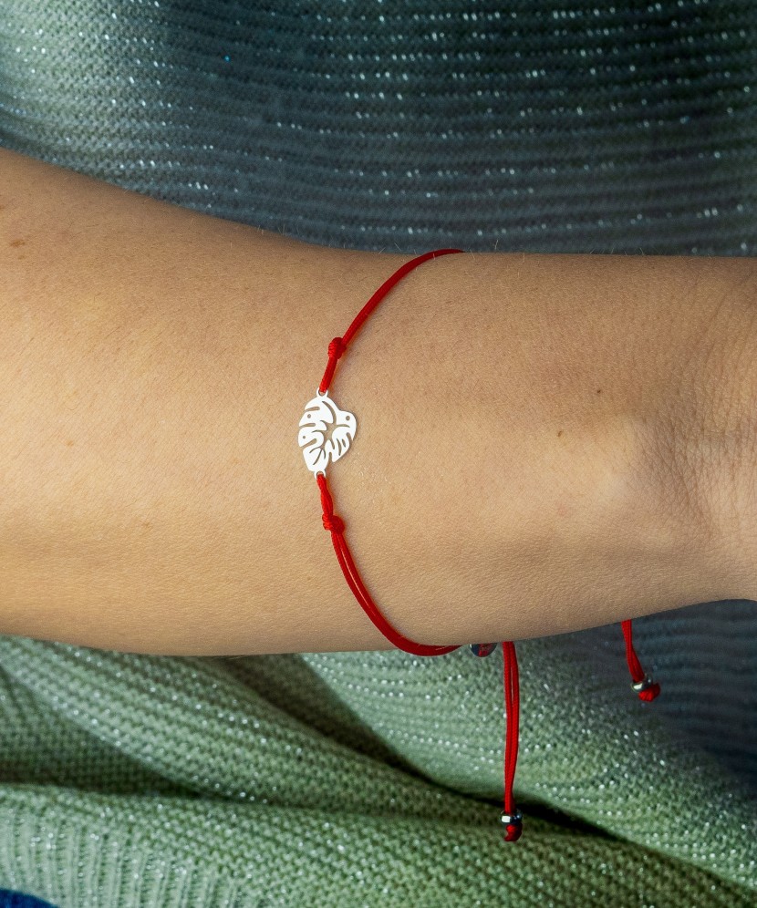 Red string bracelet with a silver pendant "leaf"
