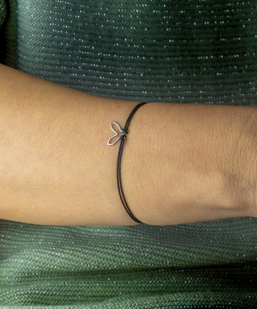 Black string bracelet with a silver pendant