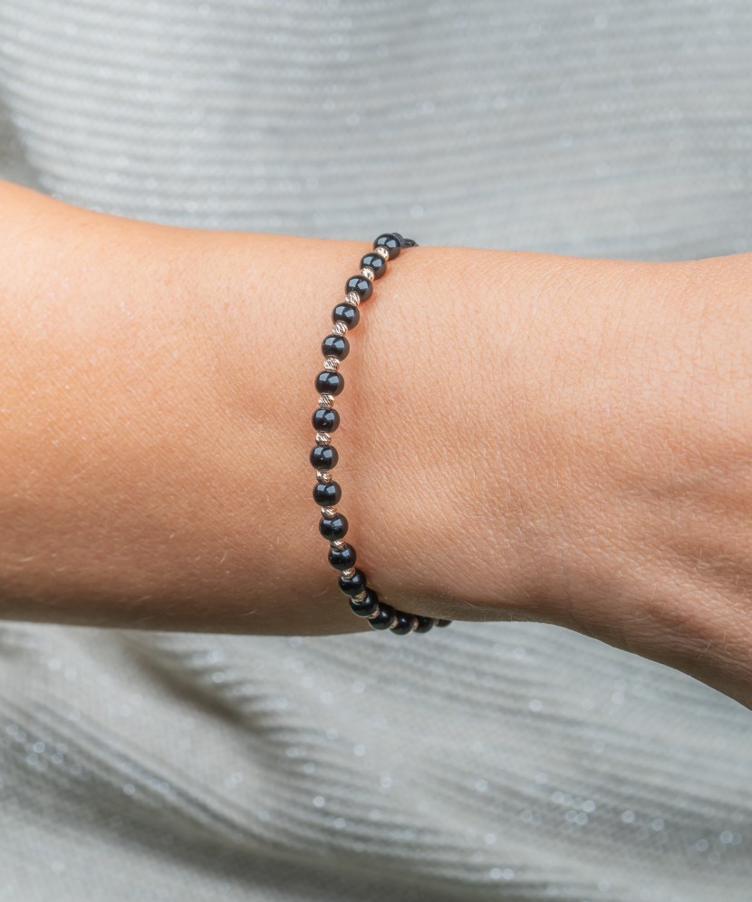 Black string bracelet with gold and onyxes