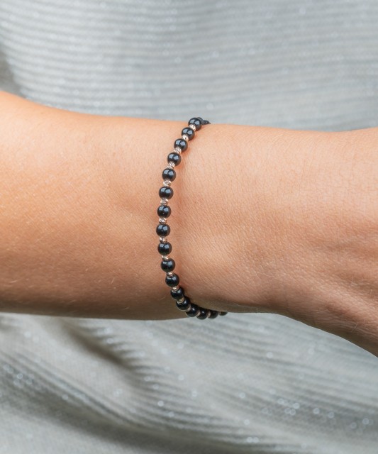 Black string bracelet with gold and onyxes