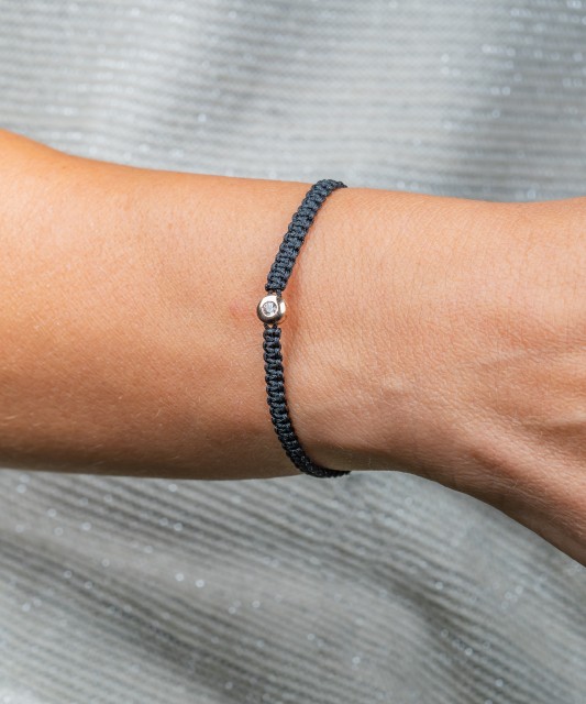 Black string bracelet with gold pendant