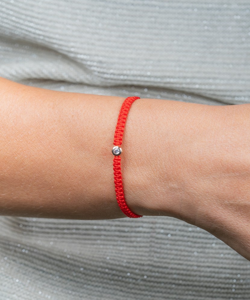 Red string bracelet with gold pendant