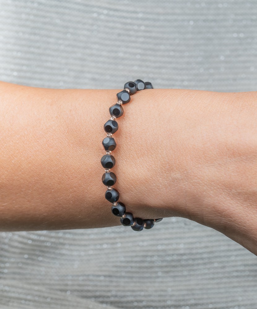 Black string bracelet with gold and onyxes