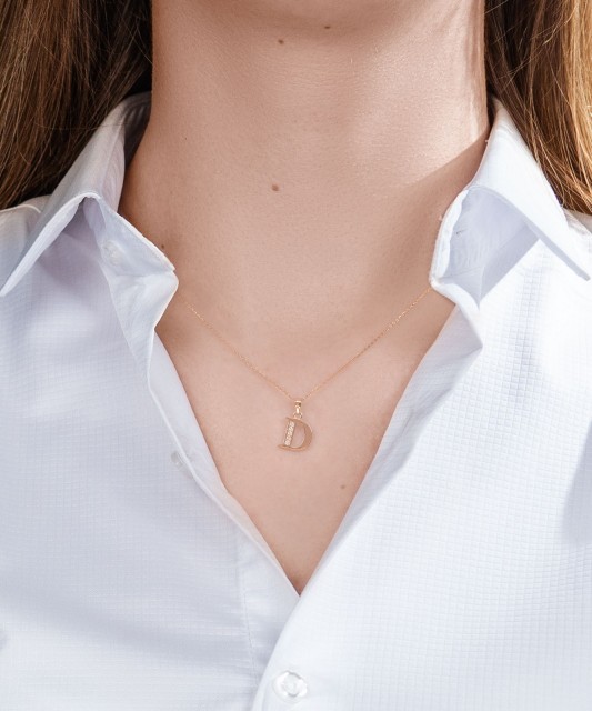 Gold pendant with zircons Letter D