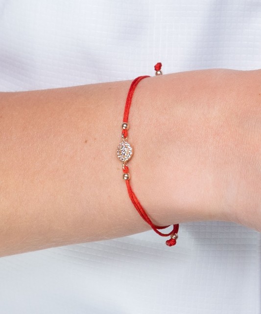 Red string bracelet with a gold pendant and zirconium