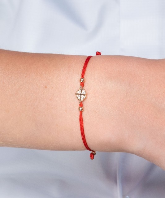 Red string bracelet with a gold pendant and zirconium "Dobilas"