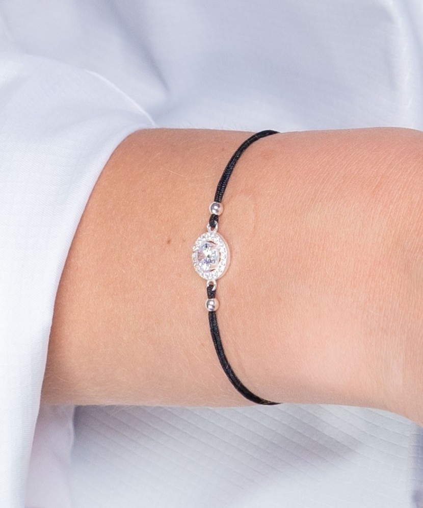 Black string bracelet with a silver pendant and zirconium