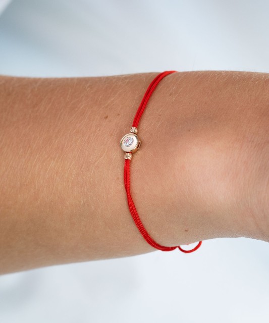 Red string bracelet with gold zirconia pendant