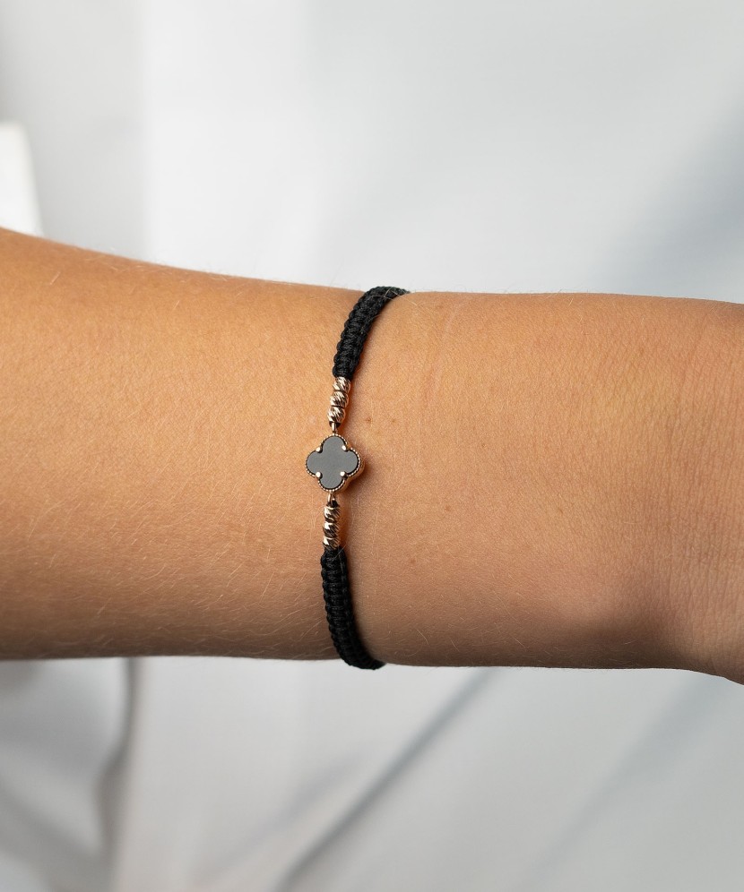 Black string bracelet with gold and onix
