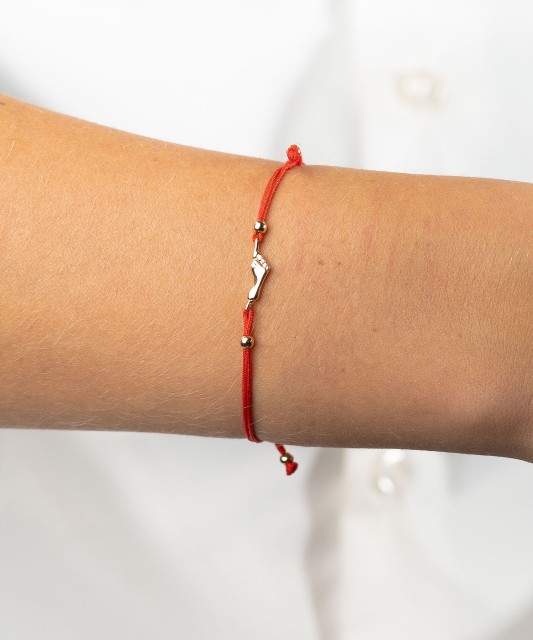 Red string bracelet with gold pendant "foot"