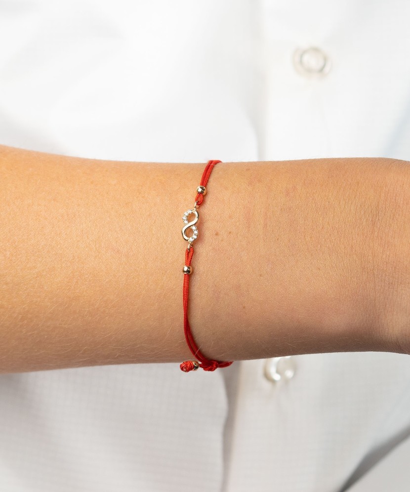 Red string bracelet with gold pendant "infinity"