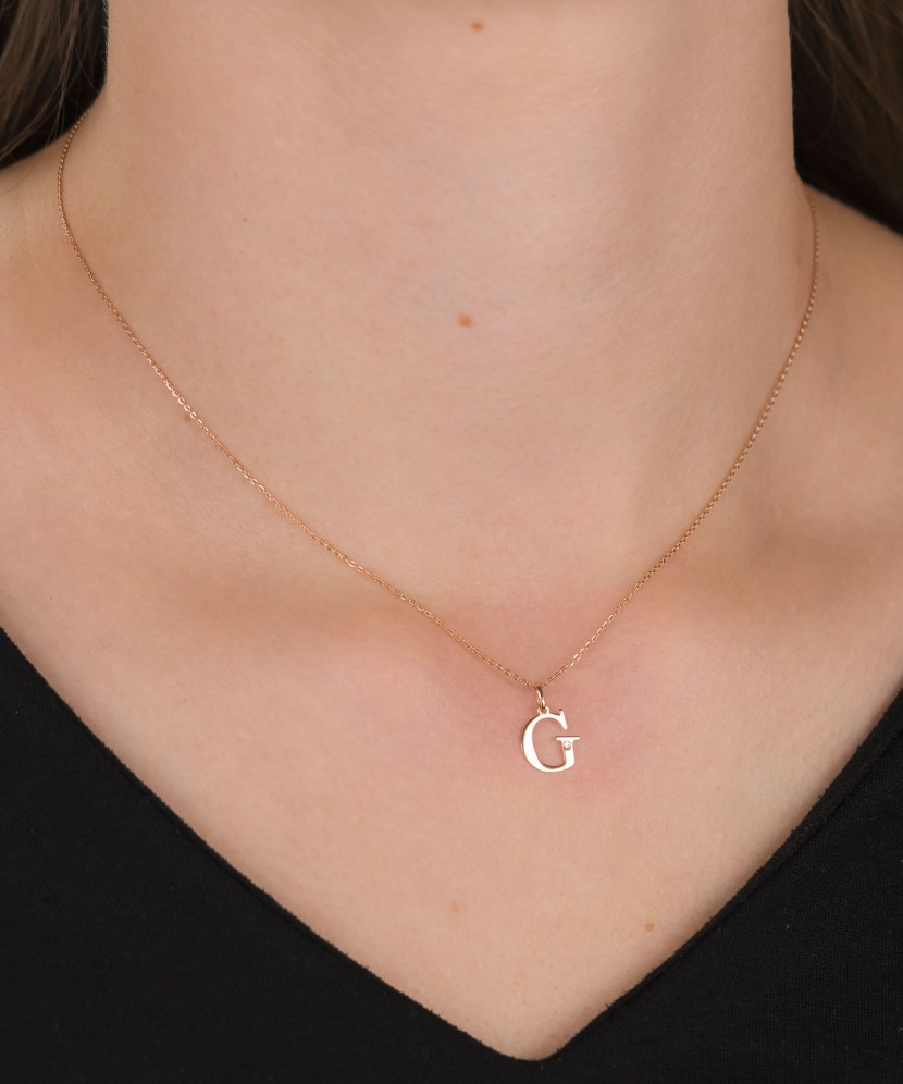 Gold pendant with diamond letter G