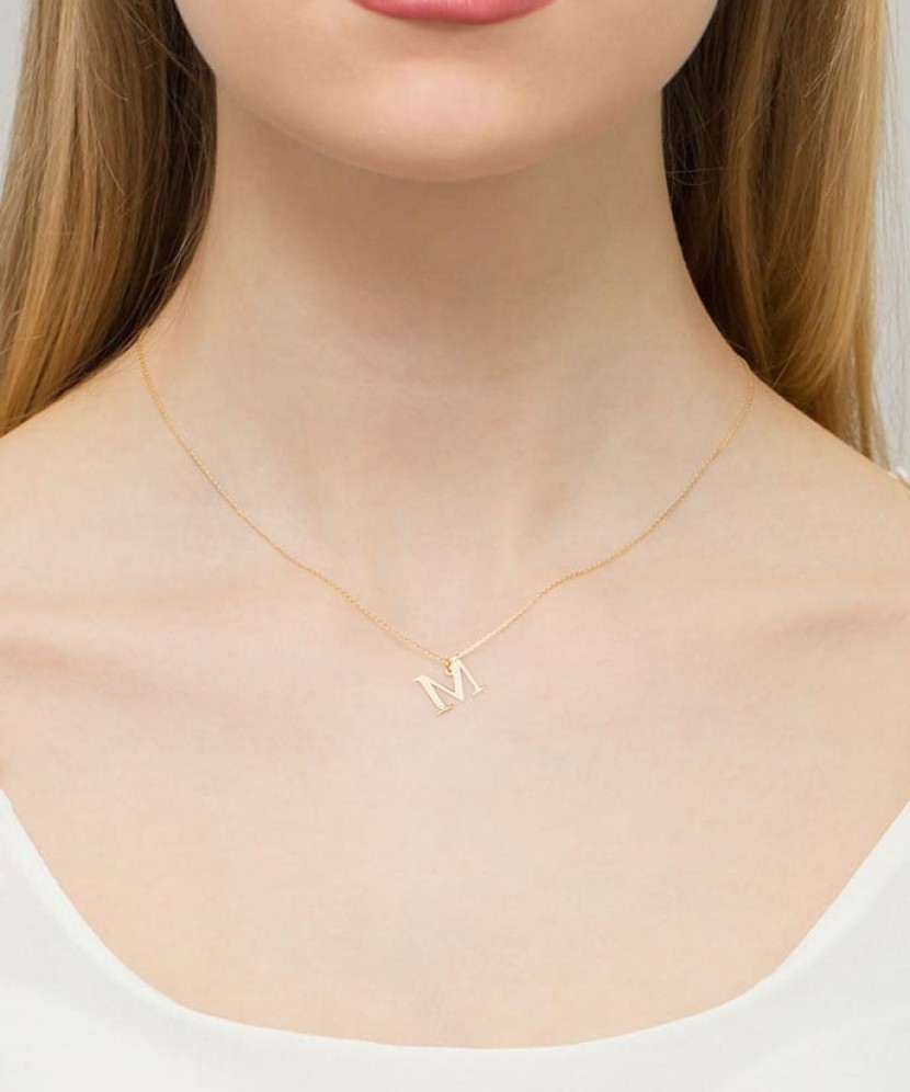 Gold pendant with diamond letter M
