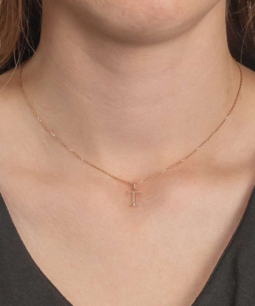 Gold pendant with diamond letter T