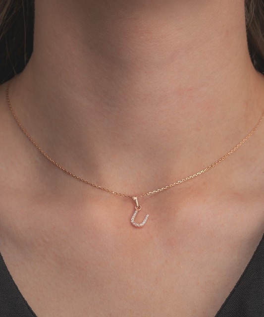 Gold pendant with zircons Letter U