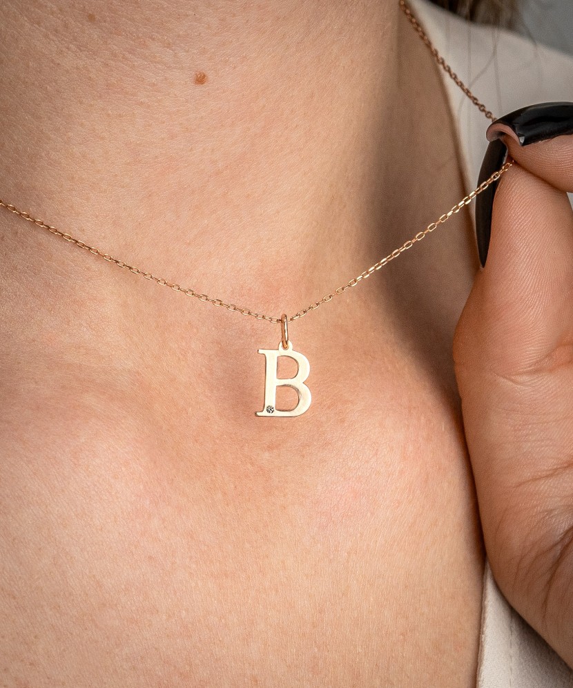 Gold pendant with diamond letter B