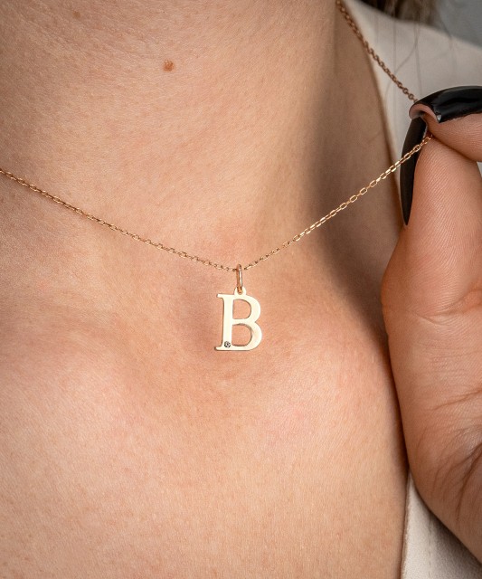 Gold pendant with diamond letter B