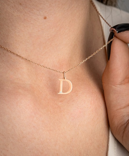 Gold pendant with diamond letter D