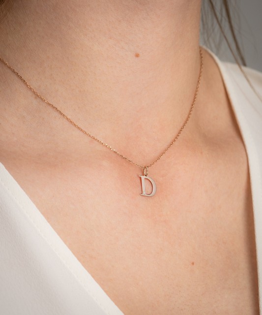 Gold pendant with diamond letter D