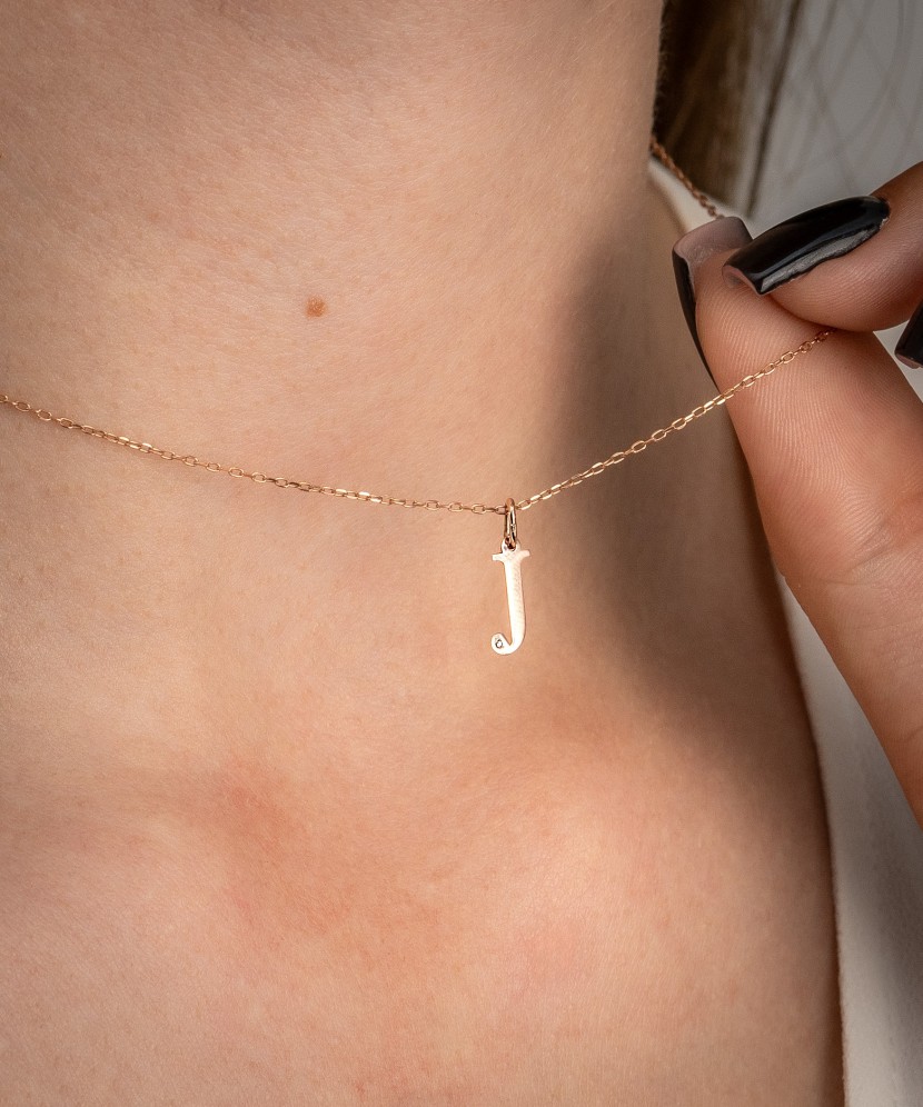 Gold pendant with diamond letter J
