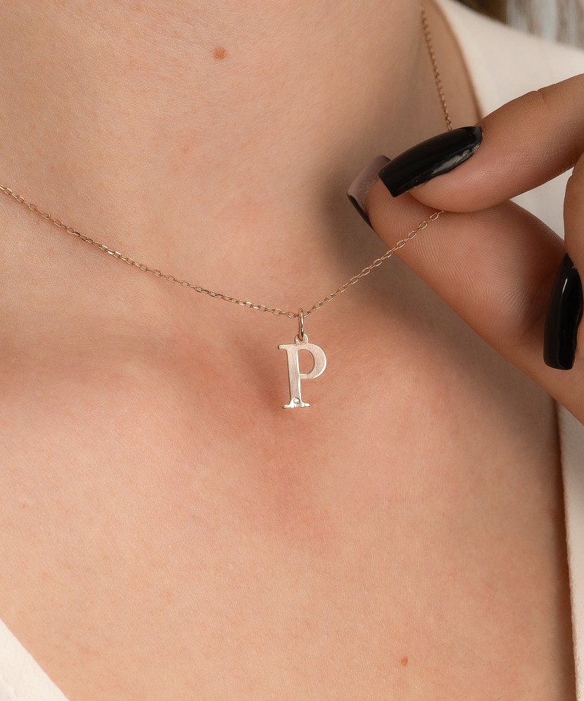 Gold pendant with diamond letter P