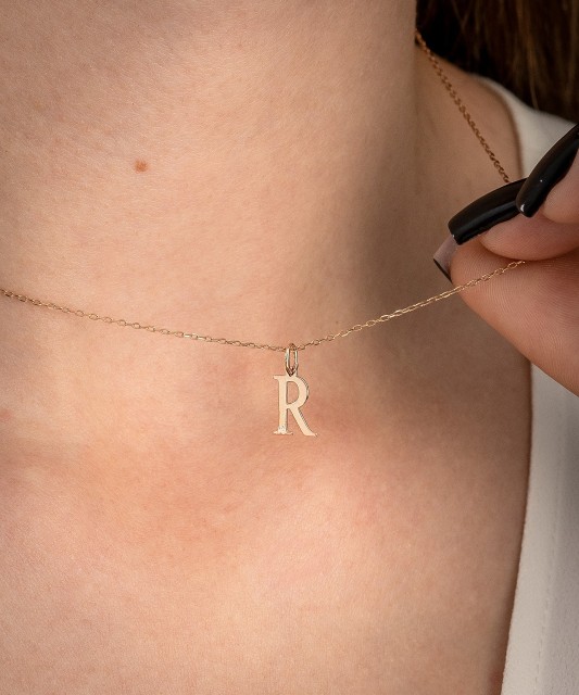 Gold pendant with diamond letter R