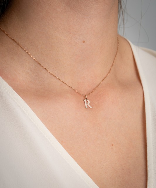 Gold pendant with diamond letter R