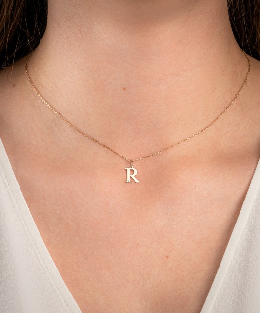 Gold pendant with diamond letter R