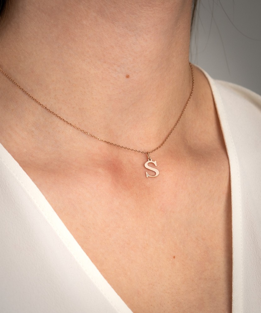 Gold pendant with diamond letter S