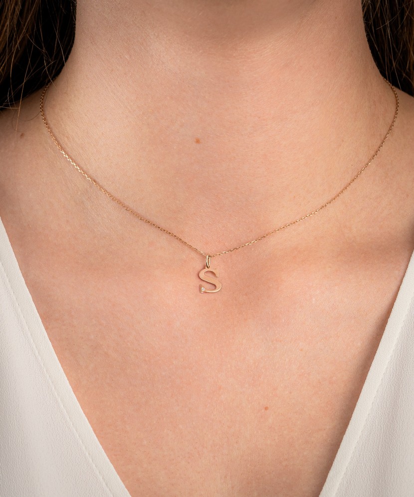 Gold pendant with diamond letter S