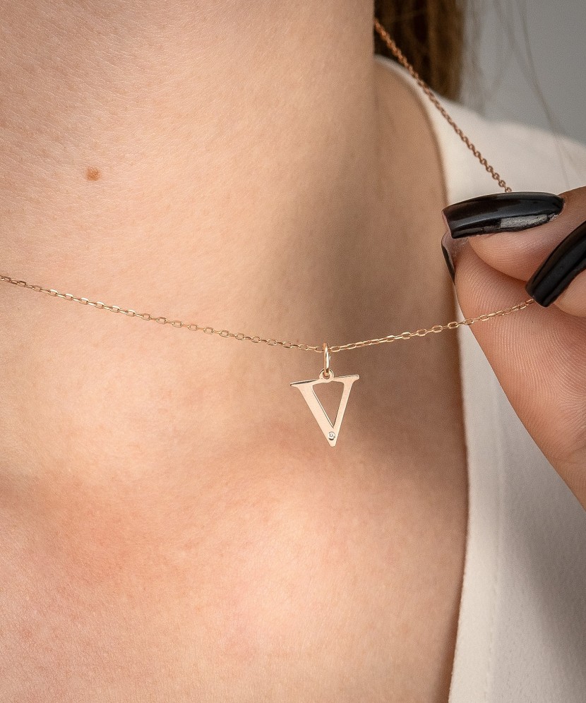 Gold pendant with diamond letter V