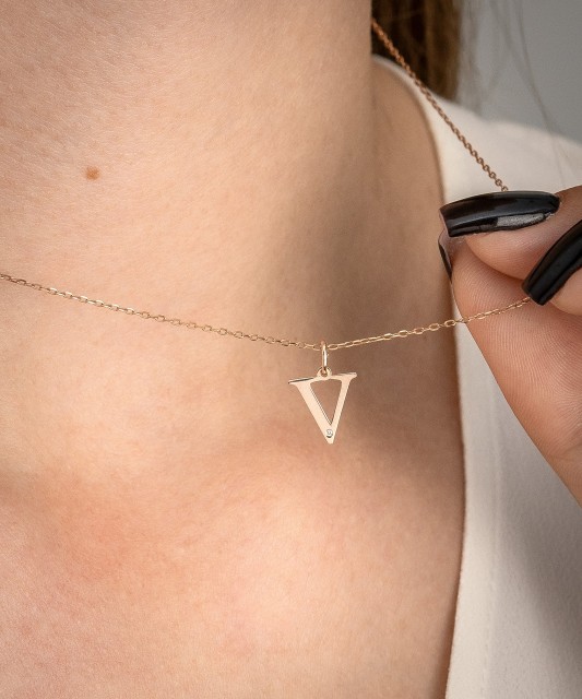 Gold pendant with diamond letter V