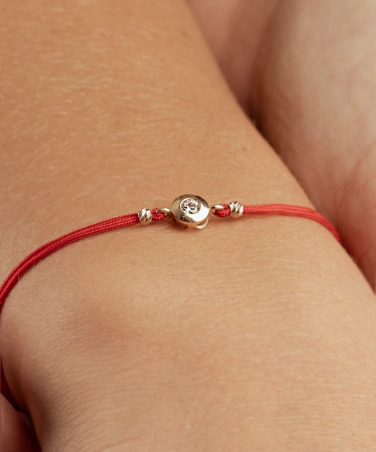 Black string bracelet with gold pendant