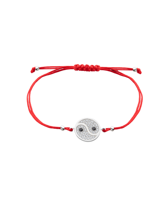 Red string bracelet with a silver pendant with zirconium