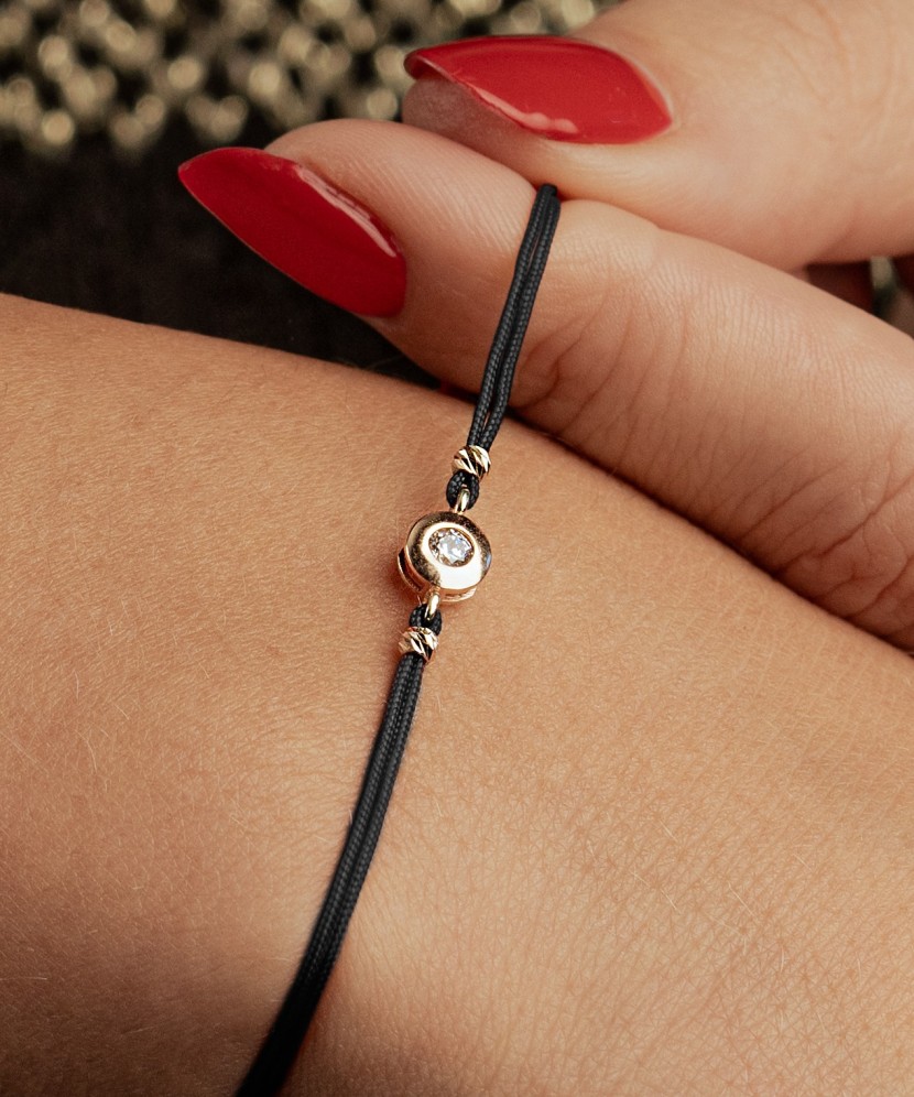 Black string bracelet with gold pendant