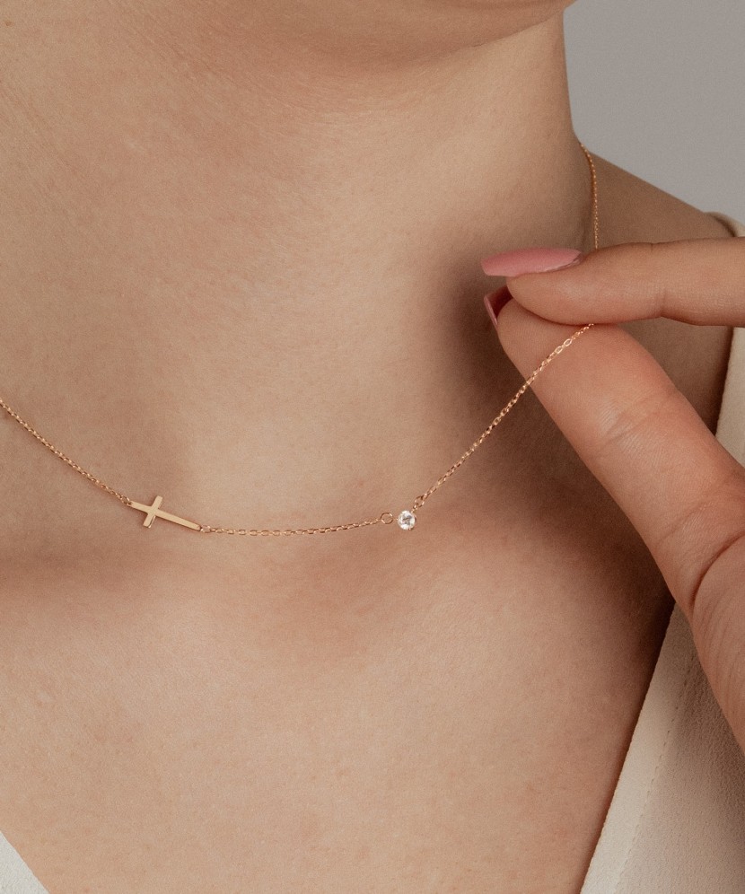Gold necklace with a zircon pendant and a cross