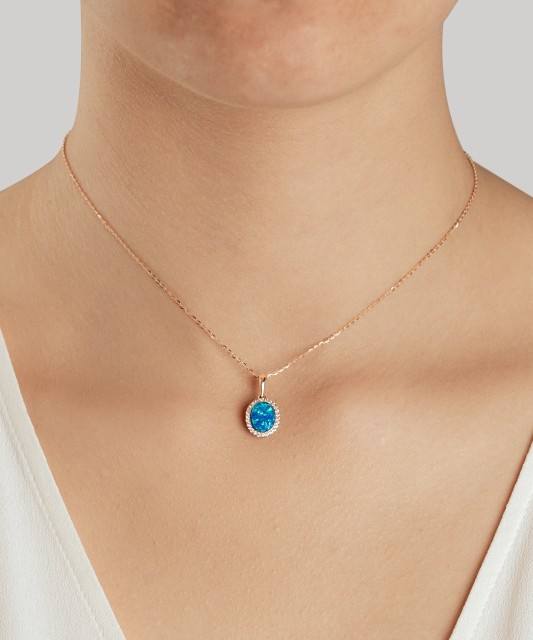 Gold pendant with opal and zircons