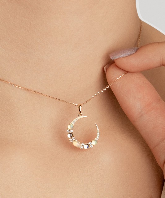 Yellow gold pendant with diamonds, opals and topazes