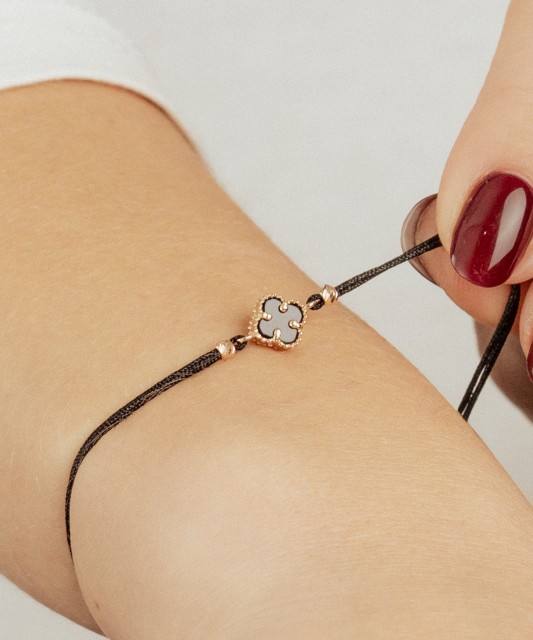 Black string bracelet with gold and onix