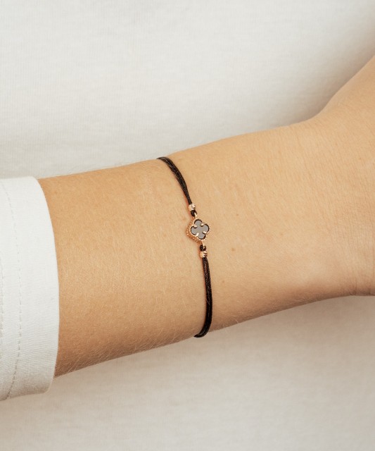 Black string bracelet with gold and onix
