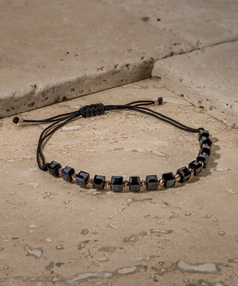 Black string bracelet with gold And Hematites