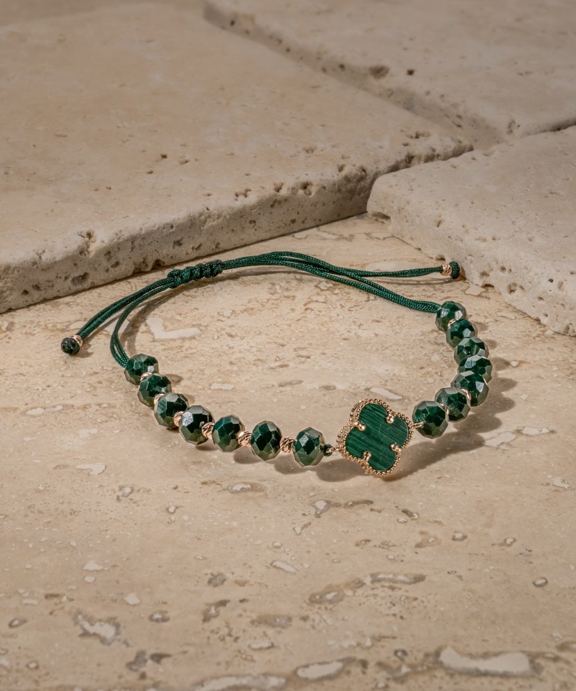 Green string bracelet with gold and onyxes