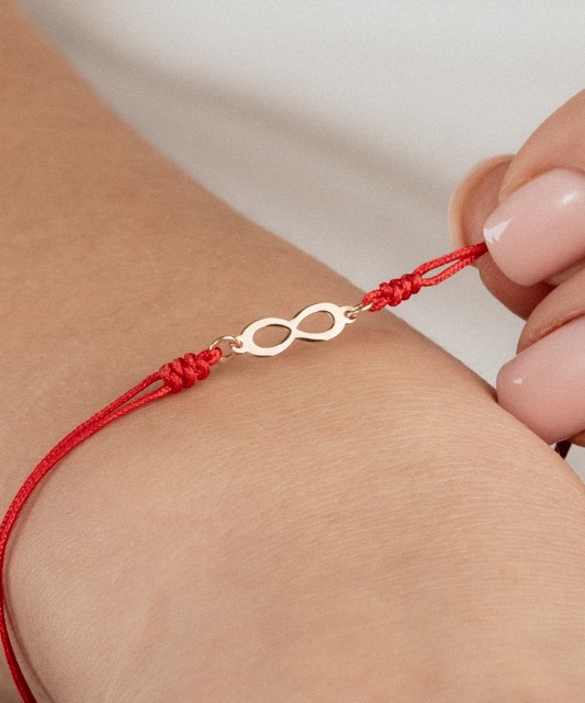 Red string bracelet with gold pendant "Infinity"