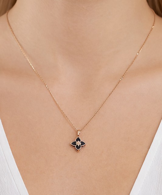 Gold pendant with onyx and zircons